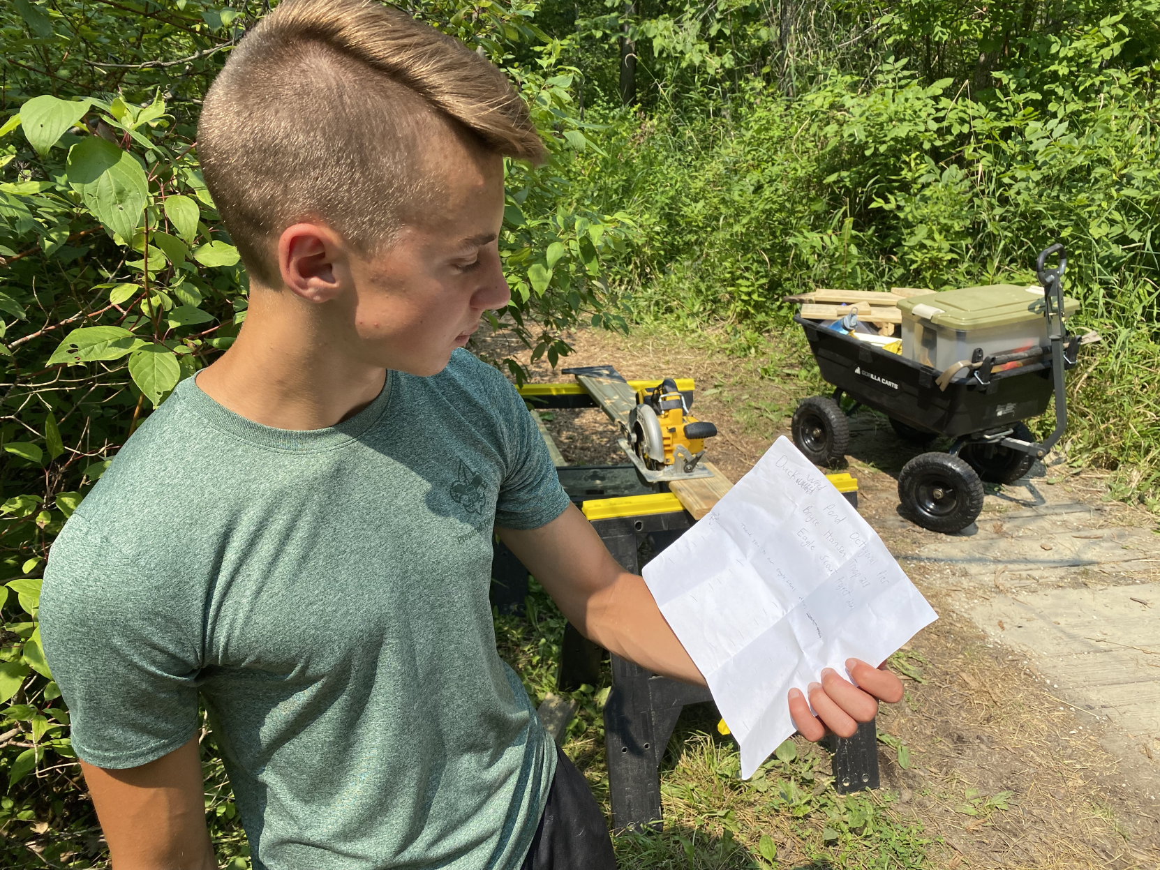 Bryce Hanson reads over inscription